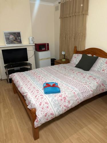 a bedroom with a bed with two blue bags on it at Kate House in London