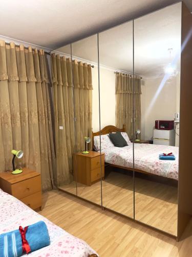 a mirror in a bedroom with two beds at Kate House in London
