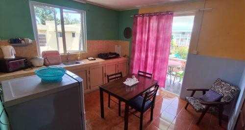 a kitchen with a table and a dining room at Chez Caze Maman in Crève Coeur