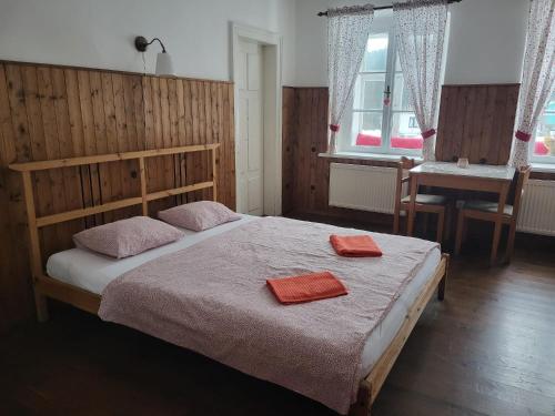 a bedroom with a bed with two towels on it at Chalupa U Bertholda in Červená Voda