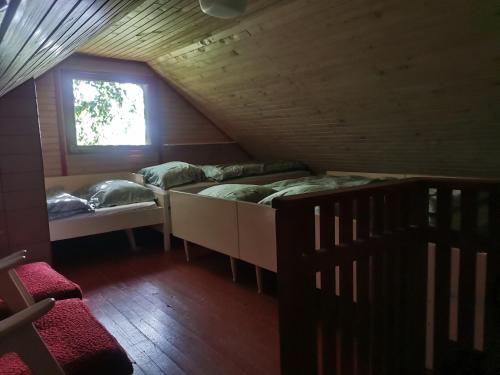 a room with two bunk beds and a window at KOZJANSKA KOČA in Podčetrtek