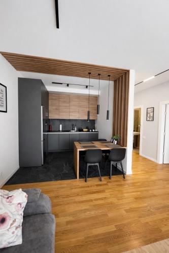 a kitchen and living room with a table and chairs at Leo Lux 2 in Niš