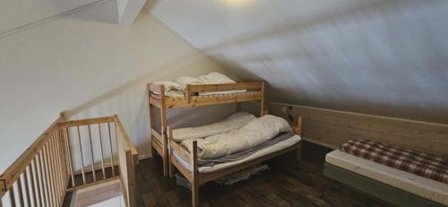 a room with two bunk beds in a attic at Apartment Røldalsfjellet in Håra