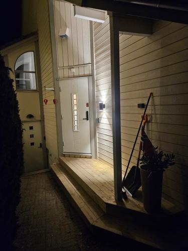 a front door of a house with a plant at Cozy 3-Bedroom Home in Forus in Stavanger