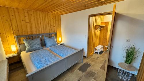 a bedroom with a bed with blue pillows on it at Gemütliche Auszeit in Burg