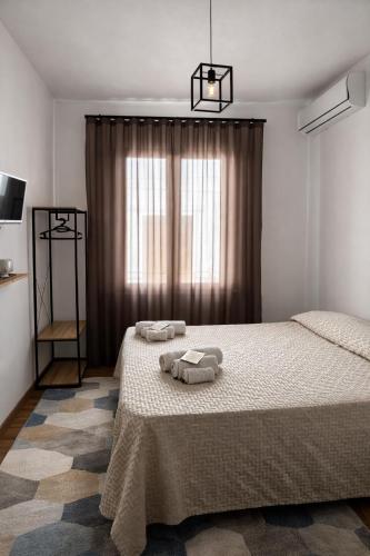 a bedroom with a bed with two towels on it at CASA NO-MA in centro storico in Marsala