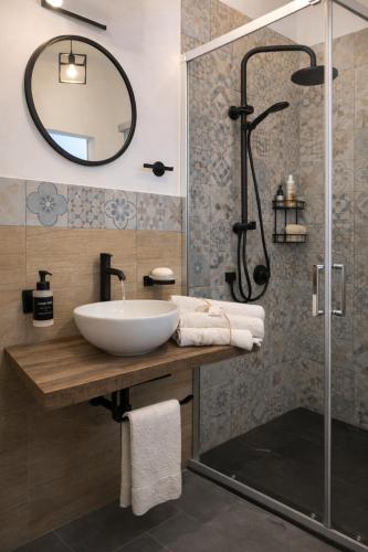 a bathroom with a sink and a shower at CASA NO-MA in centro storico in Marsala