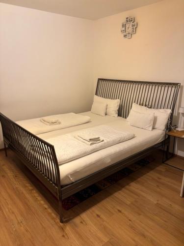 a bed in a room with white sheets and pillows at Gästezimmer Schwaz Panorama in Schwaz