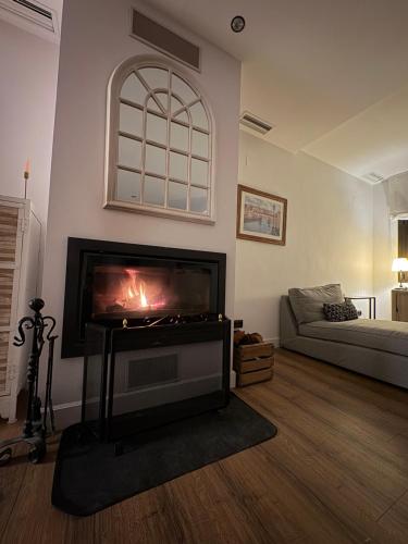 a living room with a fireplace and a couch at Finca Alboroto in Huesca