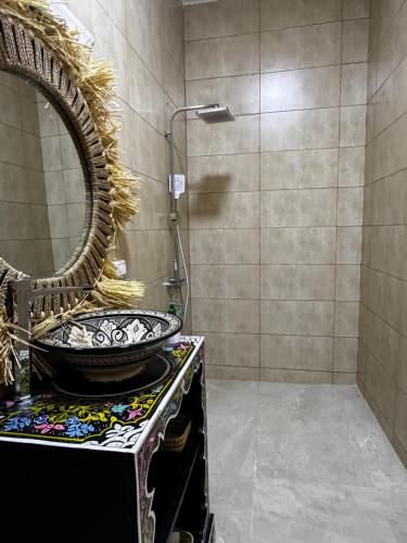 a bathroom with a sink and a mirror at Dar Laydam in Aït Zat