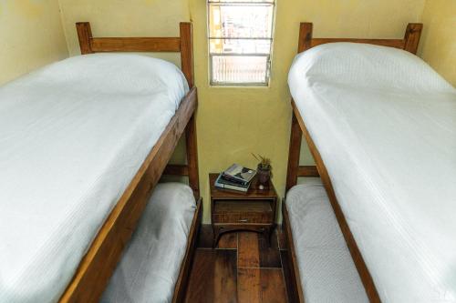 two bunk beds in a room with a window at Puertas al Cabo in Cabo Polonio