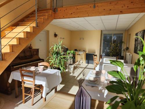 a dining room with a table and a staircase at Moulin de Montizeau in Saint-Maigrin