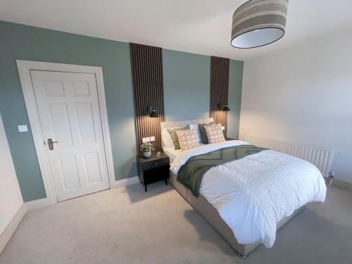 a bedroom with a bed and a white door at The Haven in Banbridge