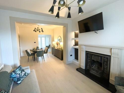 a living room with a fireplace and a dining room at The Haven in Banbridge