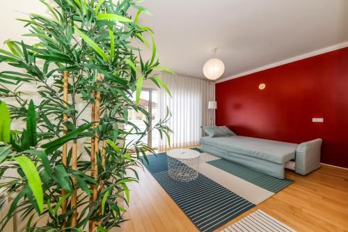 a living room with a couch and some plants at Nazare House4you in Nazaré