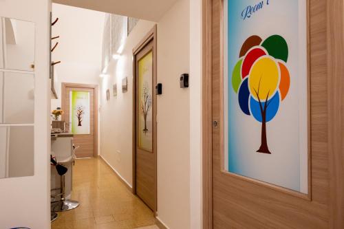 a hallway with a door and a painting on the wall at Le Gravinelle - Apulia Houses & Flats in Ruvo di Puglia