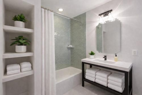 a white bathroom with a sink and a shower at Artsy Hidden Gem --- FREE PARKING in Philadelphia