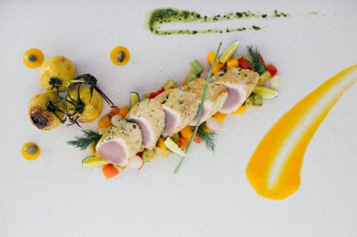 a plate of food with meat and vegetables on it at Yasawa Island Resort & Spa in Mbukama