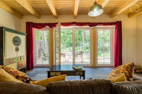 a living room with a couch and a table at Welsh Dragon in Siedlung Schönwalde