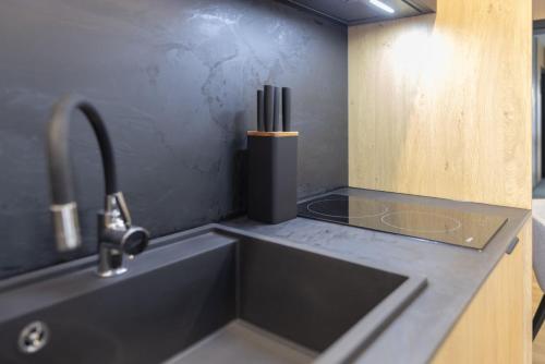 a kitchen with a sink and a counter top at Apart M in Krynica Zdrój