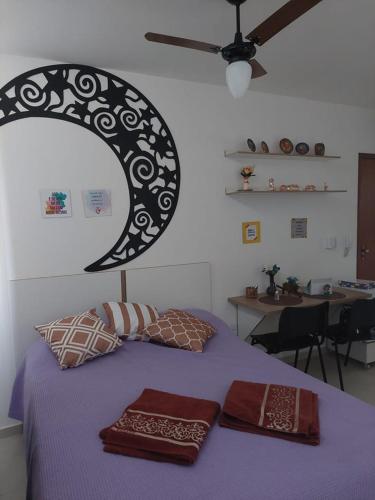 ein Schlafzimmer mit einem Bett und zwei Kissen darauf in der Unterkunft Flat da Lua in Viçosa