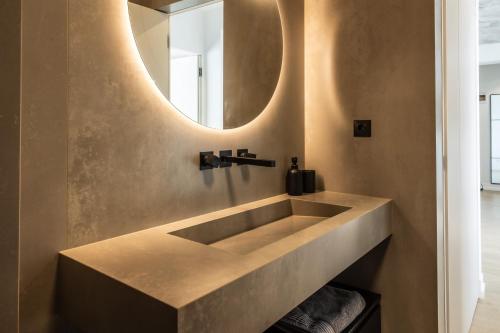 a bathroom with a large sink and a mirror at Luxury Blue Apartment in Satu Mare