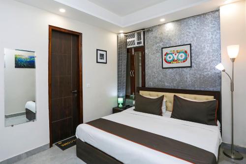 a bedroom with a large bed in a room at Hotel O The Signature inn in Indirapuram