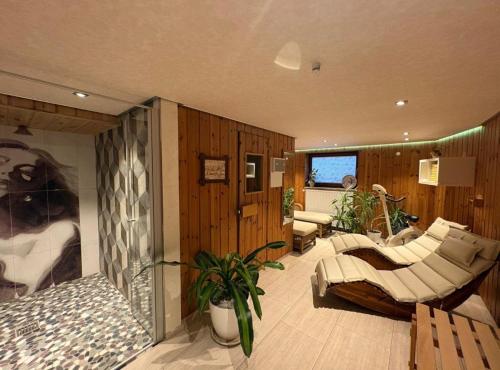 a living room with a couch and a chair at Zugspitze 6 mit SAUNA in Farchant bei Garmisch-Partenkirchen in Farchant