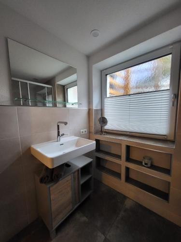 a bathroom with a sink and a large window at Ferienwohnung Pöll in Stanz bei Landeck