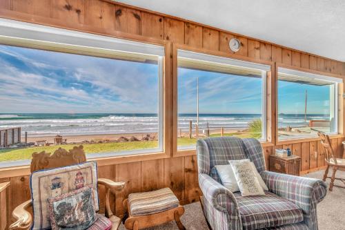 a living room with a view of the ocean at Beach Bungalow - Roads End in Lincoln City