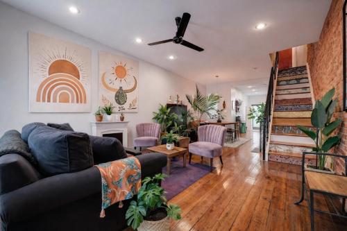 a living room with a couch and a fireplace at Artsy Hidden Gem -- FREE PARKING in Philadelphia