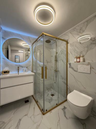 a bathroom with a glass shower and a toilet at City Center Lux Studio in Athens