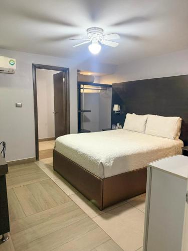 a bedroom with a bed and a ceiling fan at Nueva Vizcaya & Suites in Hidalgo del Parral