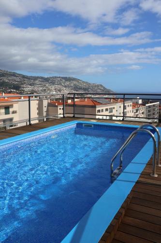 a swimming pool on the roof of a building at Apartamento Batista in Funchal