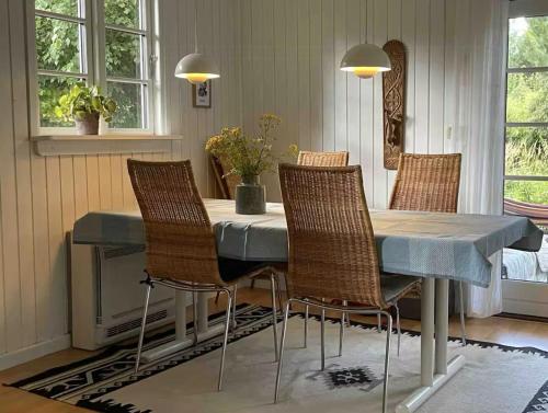 a dining room with a table and chairs at Seaside Cabin With Ocean View In Odsherred in Nyrup