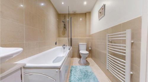 a bathroom with a tub and a toilet and a sink at 15 min walk to Tower Bridge in London