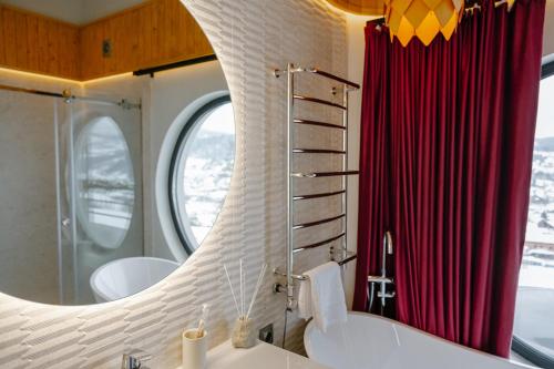 a bathroom with two sinks and a large mirror at Vershok villa in Slavske