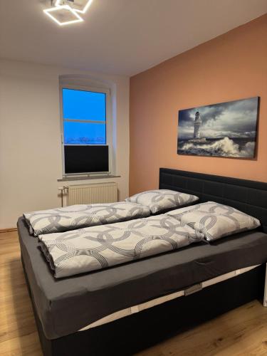 a bed in a room with a window at Pension zum Kanal in Burg bei Magdeburg
