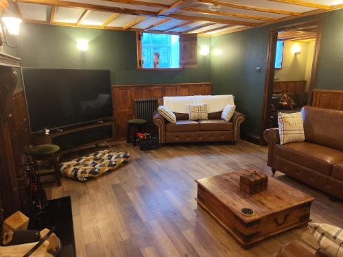 a living room with a couch and a tv at Bradford Canal Pump House, Shipley near Saltaire in Shipley