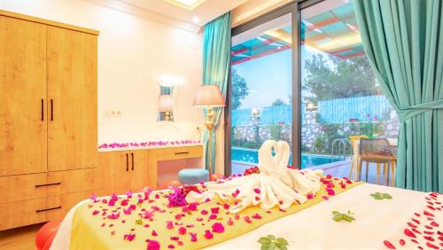 a bedroom with a bed with flowers on it at Villa Adalya in Kaş