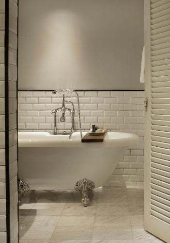a white bath tub with a faucet in a bathroom at Hotel Once Bangkok in Bangkok