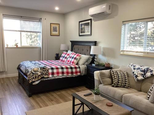 a bedroom with a bed and a couch at The Cozy Nook in Grand Forks