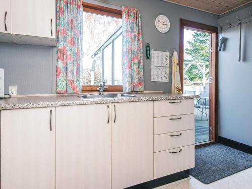 a kitchen with a sink and a window at 4 person holiday home in Juelsminde in Snaptun