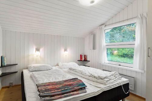 a white room with a bed with a window at 931-Thisted-Pinbak-24 in Torsted