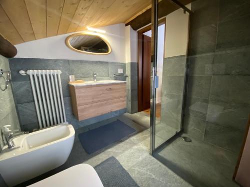 a bathroom with a toilet and a sink and a shower at Villa Vetto in Lanzada