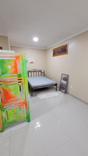 a room with a bed and a couch in it at Cantinho do sossego in Capão da Canoa