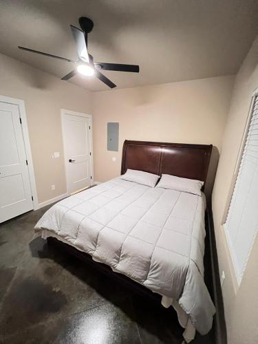 a bedroom with a bed with a ceiling fan at Special Deal on Booking Unit 664 in Paris