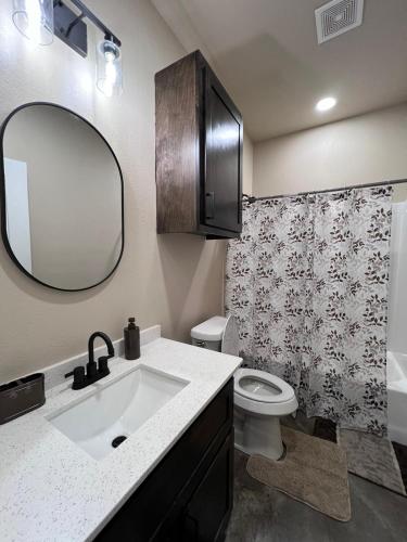 a bathroom with a sink and a toilet and a mirror at Special Deal on Booking Unit 664 in Paris