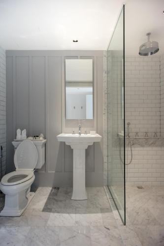 a bathroom with a toilet and a sink and a shower at Hotel Once Bangkok in Bangkok