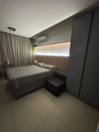 a small bedroom with a bed and a light at Flat Azzure 205 in Cabedelo